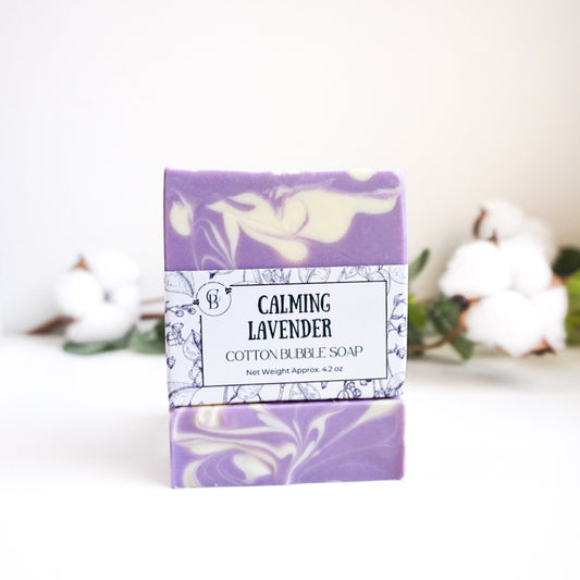 Bar of soap with a purple and white label on a white background