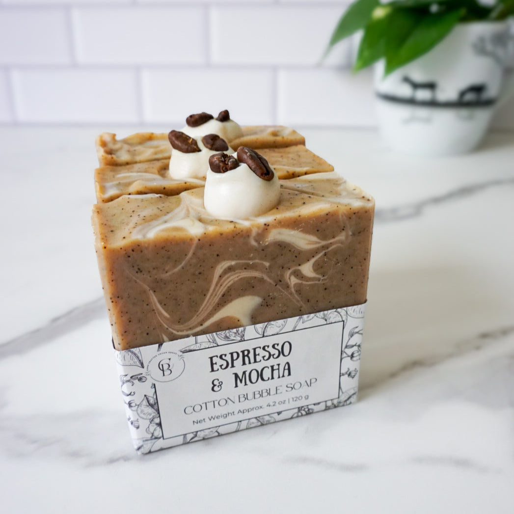 Bar of soap with coffee-themed packaging on a marble surface