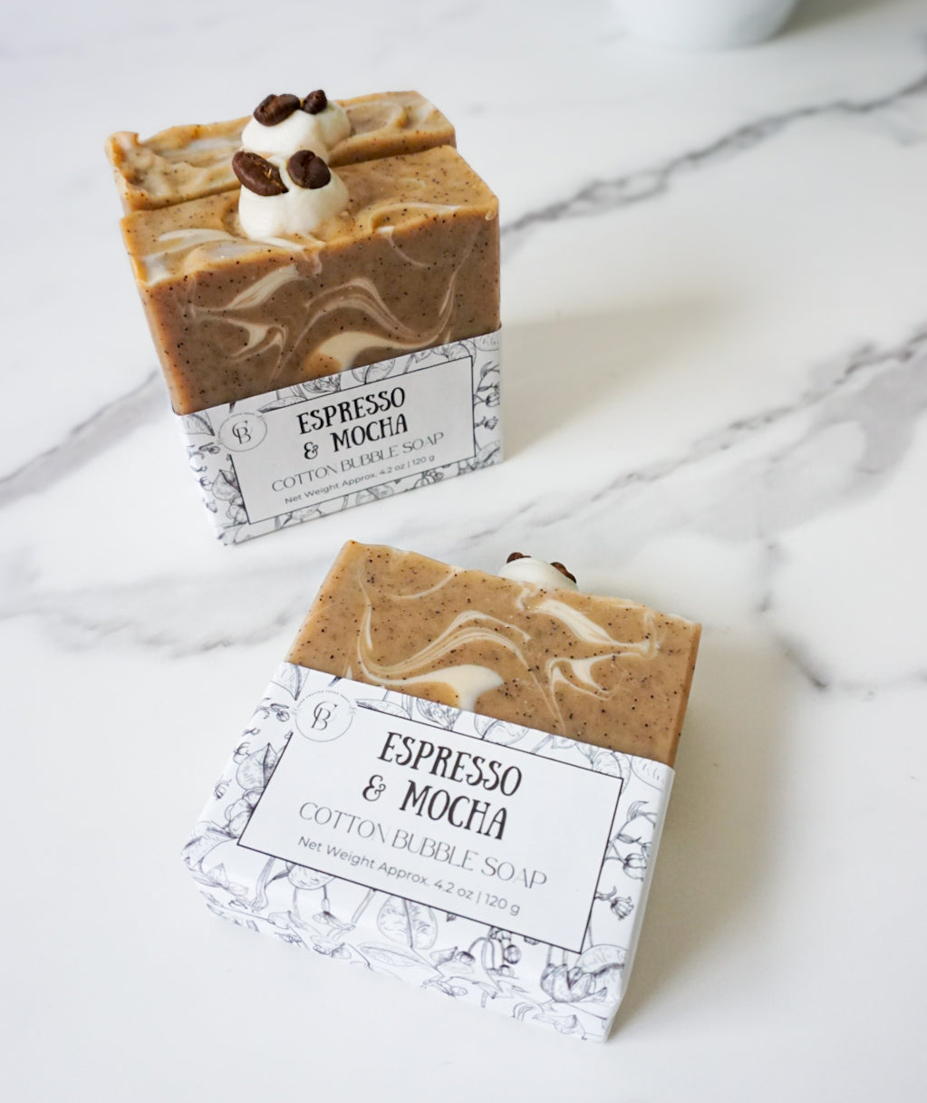 Two bars of Espresso & Mocha soap with packaging on a marble surface.