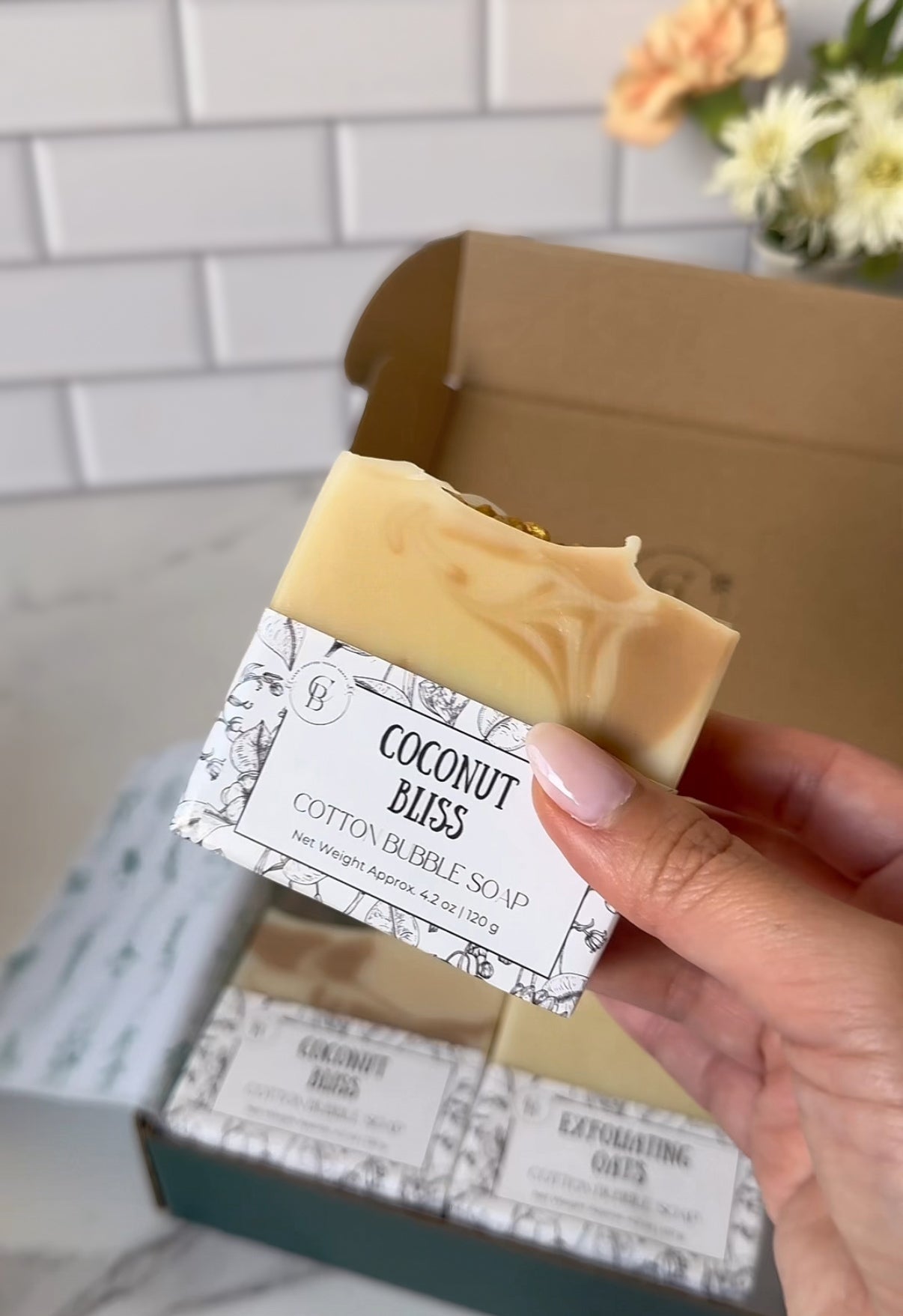 A hand holding Coconut Bliss Soap