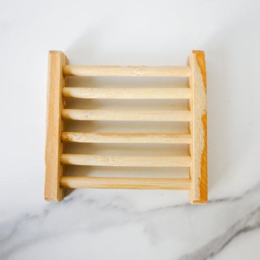 Wooden soap dish on a marble surface