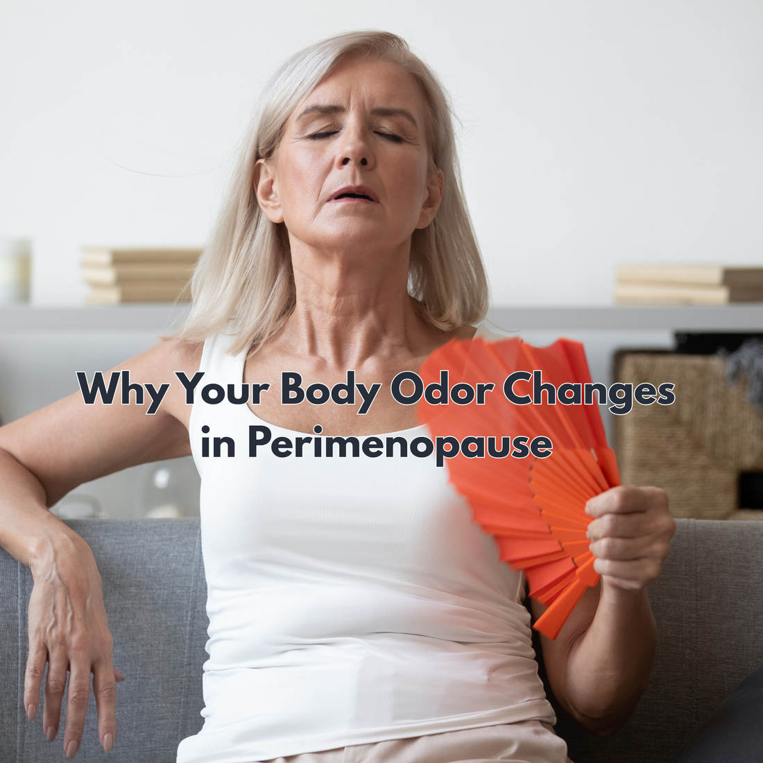 old woman using a handheld fan for her menopause with a picture caption "Why Your Body Odor Changes in Perimenopause "