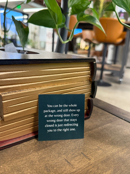 Book with a black label on a wooden surface, blurred indoor background