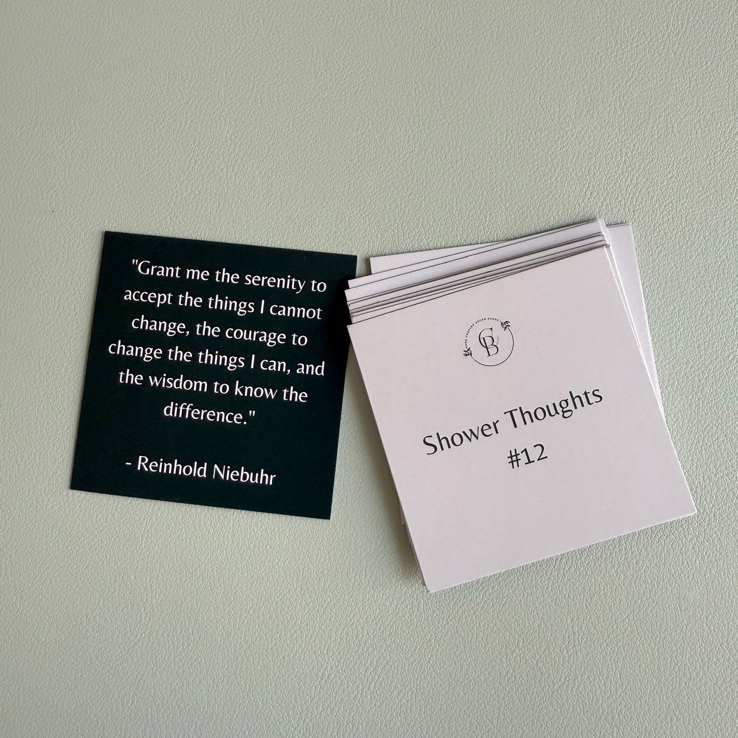 one card with a quote and a stack of cards with text on a light gray background
