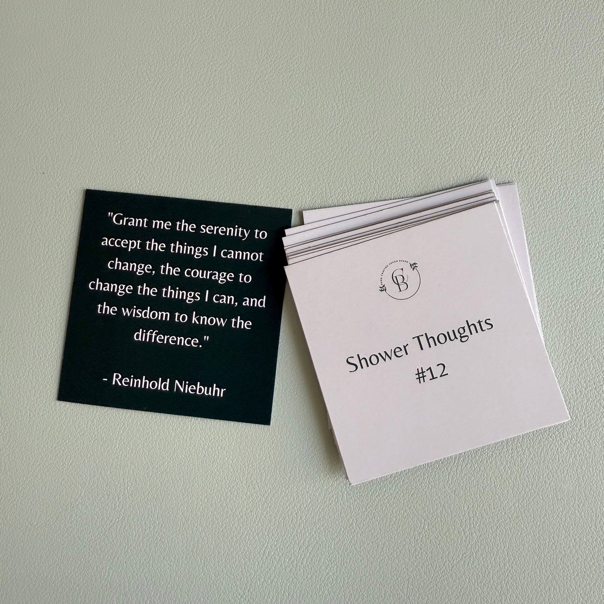 one card with a quote and a stack of cards with text on a light gray background