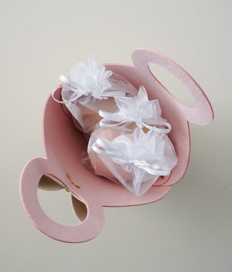 3 white pouches in a pink gift bag