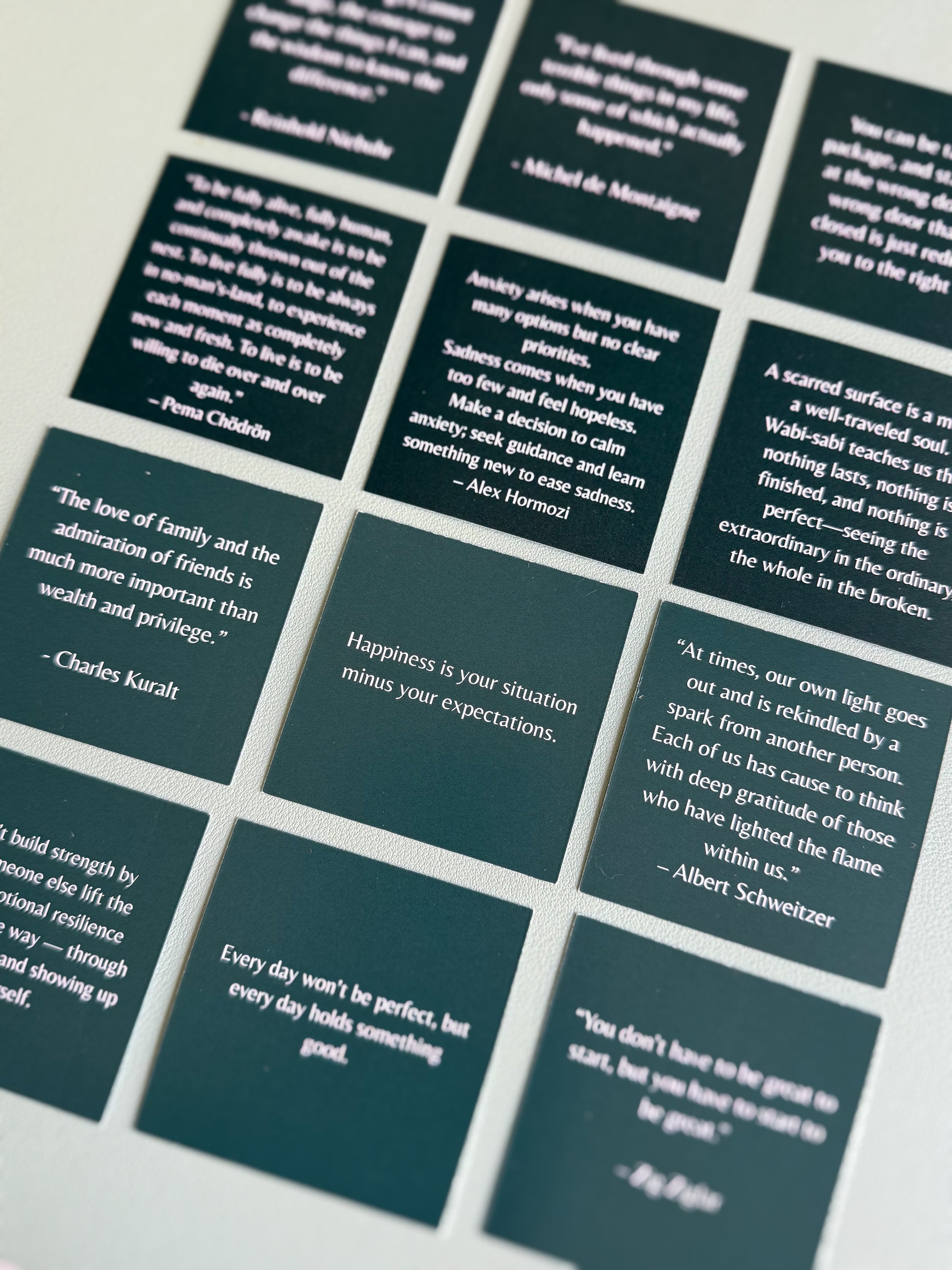 Set of dark green cards with white text quotes on a light gray background