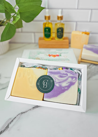 handcrafted soap bars (yellow or purple) in a white box
