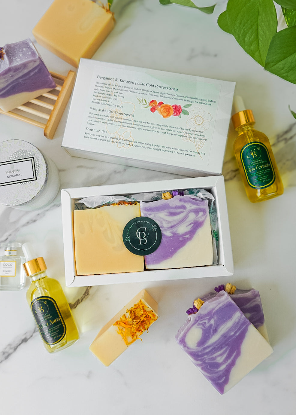 handcrafted soap bars (yellow or purple) and oils in a glass bottle