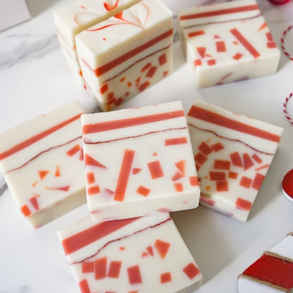 Marbled red and white soap bars on a white surface