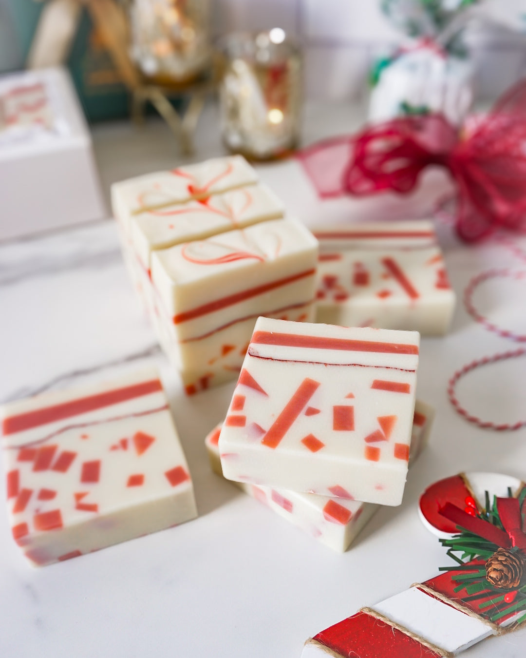 Decorative soap bars with red and white pattern on a white surface.