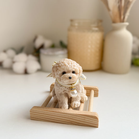 Small dog figurine soap on a wooden stand with decorative items in the background