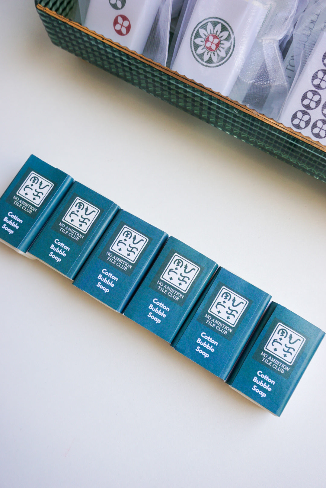 Row of blue soap boxes with a brand logo on a light surface.
