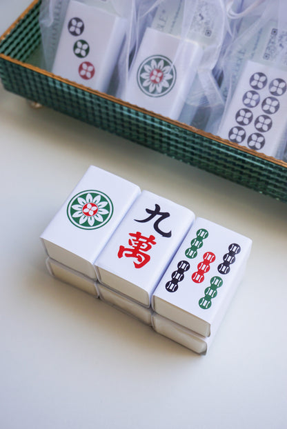 Stack of Mahjong tiles with a green tray in the background