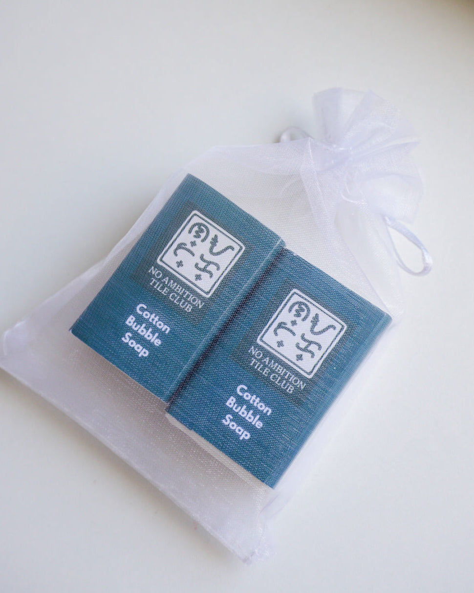 Cotton bubble soap packaging with a white drawstring bag on a light background
