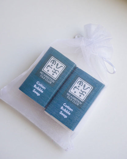 Cotton bubble soap packaging with a white drawstring bag on a light background