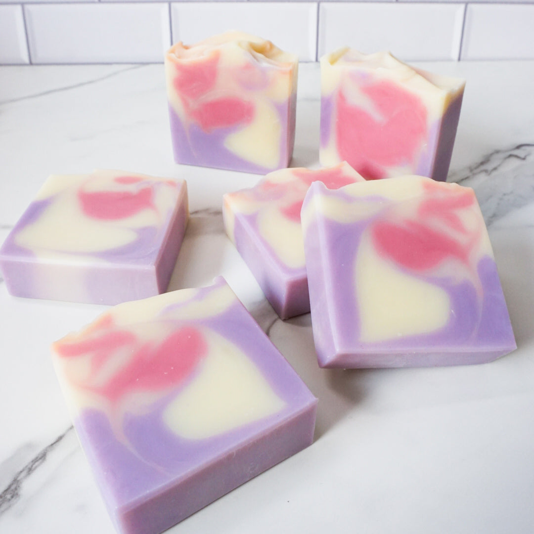 vanillaraspberryblueberry themed soaps on a white marble surface