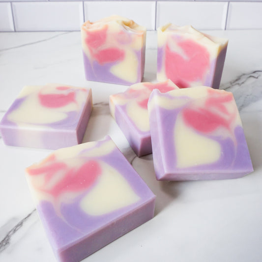 vanillaraspberryblueberry themed soaps on a white marble surface